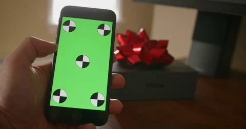 IPhone 8 being used by pressing and swiping next to apple box with red bow with Video stock 82848110