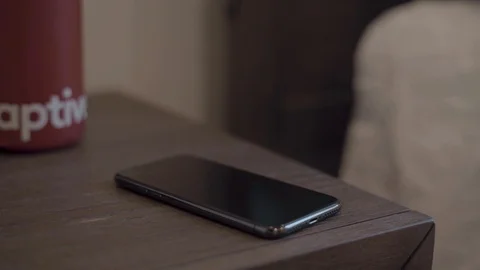Iphone alarm, man grabbing iphone, 4K Stock Footage 124279517