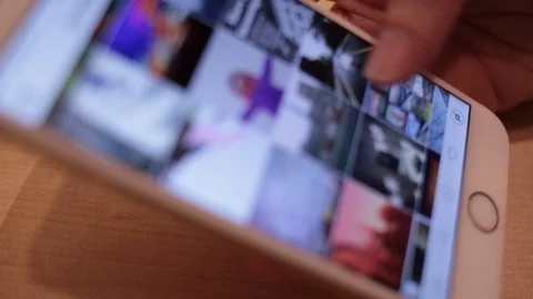 IPhone Browsing Instagram Photos Video stock 102187779