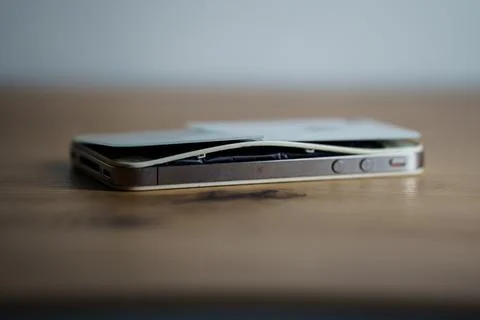 Iphone with exploded Lithium-ion battery. Li-ion swollen battery Stock Photos