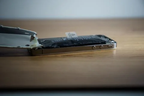 Iphone with exploded Lithium-ion battery. Li-ion swollen battery Stock Photos