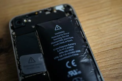 Iphone with exploded Lithium-ion battery. Li-ion swollen battery Stock Photos