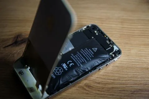 Iphone with exploded Lithium-ion battery. Li-ion swollen battery Stock Photos