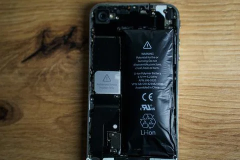 Iphone with exploded Lithium-ion battery. Li-ion swollen battery Stock Photos