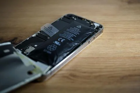 Iphone with exploded Lithium-ion battery. Li-ion swollen battery Stock Photos