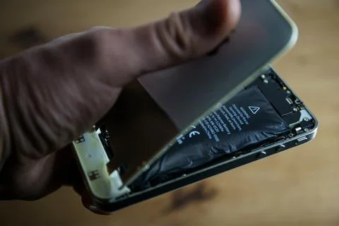Iphone with exploded Lithium-ion battery. Li-ion swollen battery Stock Photos