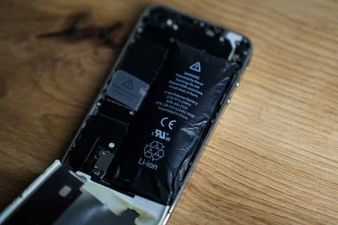 Iphone with exploded Lithium-ion battery. Li-ion swollen battery Stock Photos