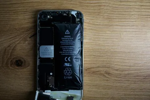Iphone with exploded Lithium-ion battery. Li-ion swollen battery Stock Photos