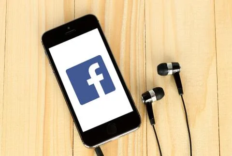 IPhone with Facebook logotype on its screen Stock Photos