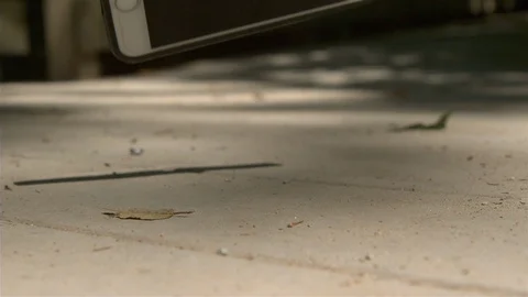 IPhone falling and hitting ground slow motion Stock Footage 111399973
