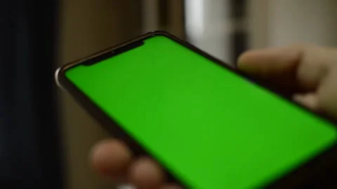 Iphone green screen. caucasian man's hand hold iphone in a blur background. Stock-Footage 227130658