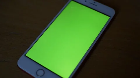 Iphone green screen display on the wood desk. camera motion on iphone screen. Stock Footage 235991753