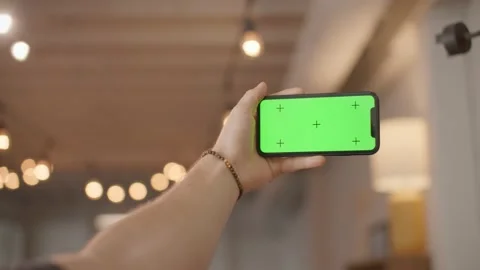 Iphone green screen mockup, holding phone landscape with trendy lights 库存影片 218467041