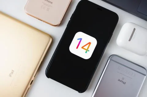 IPhone with iOS 14 logo on the screen. Stock Photos