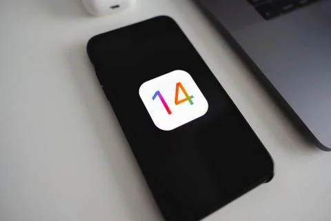 IPhone with iOS 14 logo on the screen. Stock Photos