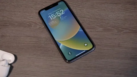 IPhone with IOS 16 and AirPods Pro, Tilt, Medium Stock Footage 217767167