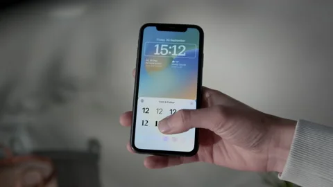 IPhone with IOS 16 customizing lock screen, POV Stock Footage 217765748