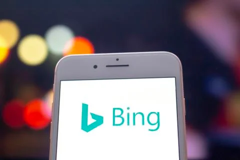 An iPhone Plus with a Bing logo on the screen. Stock Photos
