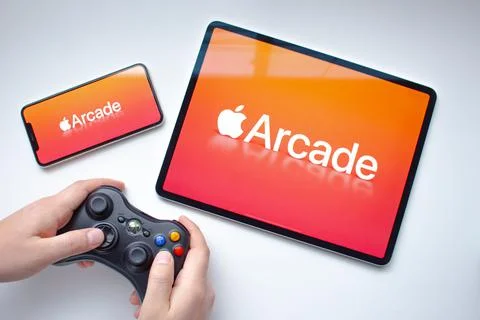 An iPhone Pro and an iPad Pro with the Apple Arcade logo on their screens  Stock Photos