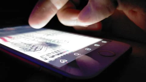 Iphone scroll in the dark. Young man use iphone display with social media app. Stock-Footage 249108863