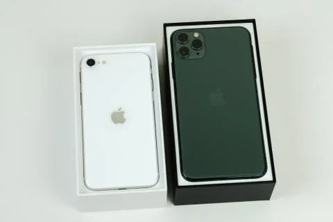 IPhone SE 2020 (2nd Generation) and iPhone 11 Pro Max in midnight green. Stock Photos
