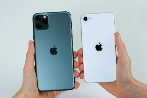 IPhone SE 2020 (2nd Generation) and iPhone 11 Pro Max in midnight green. Stock Photos