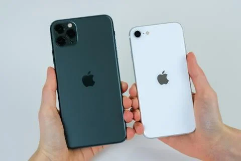 IPhone SE 2020 (2nd Generation) and iPhone 11 Pro Max in midnight green. Stock Photos