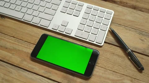 Iphone six on desk with keyboard Видео 64048386