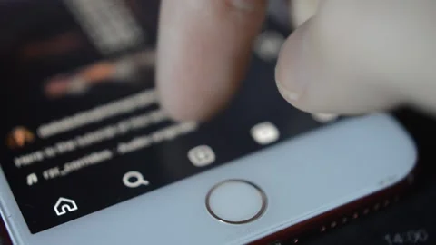 Iphone social network app. man scroll video on instagram app in the iphone. Stock Footage 234873447