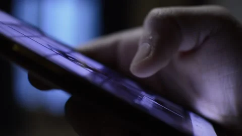 Iphone telecommunication concept. man's hand use iphone in the dark night. Stock Footage 230149097