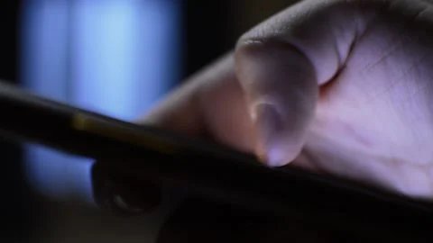 Iphone telecommunication concept. man's hand use iphone in the dark night. Stock Footage 230149127