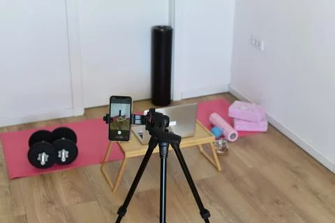 IPhone on tripod capturing home workout setup Stock Photos