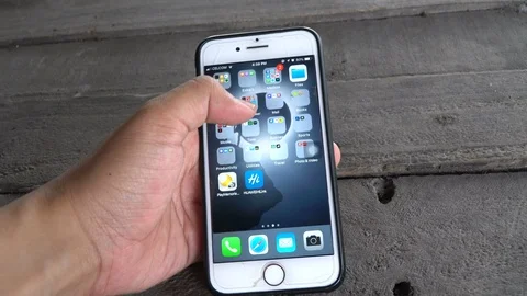 An Iphone user opening and scrolling Facebook Stock Footage 88381162