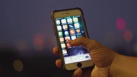 Iphone user using Twitter apps, browsing and scrolling the screen Stock Footage