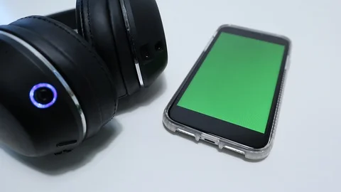 IPhone Wireless Headphones Placed into Frame with Greenscreen on smartphone 動画素材 127727110