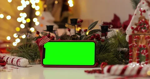 IPhone Xs Max smartphone with pre keyed green screen and Santa Claus' hat on top Stock Footage 144375294