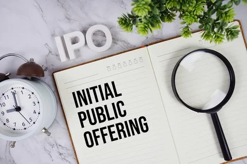 IPO - Initial Public Offering acronym on notepad, Business concept background Stock Photos