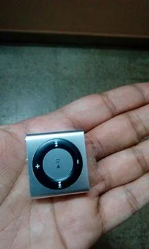 Ipod Shuffle Held in Hand Stock Photos