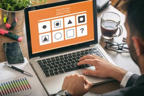 IQ test. Man working with a computer laptop, online Intelligence test form on Illustrazione stock