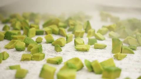IQF Diced Avocado Cubes Under Cold Mist on White Freezer Bed 스톡 동영상 346738819