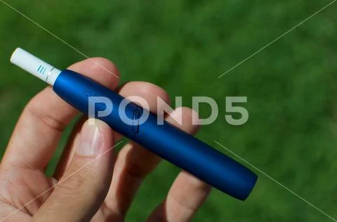 IQOS 3 electronic cigarette device with heat-not-burn system Stock Photos
