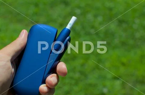 IQOS 3 electronic cigarette device with heat-not-burn system Stock Photos