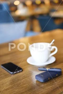 IQOS heat-not-burn tobacco product technology. Stock Photos