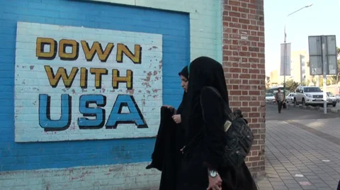 Iran, Down with USA mural painting, veiled women, former US Embassy, Tehran Stock-Footage 33908341