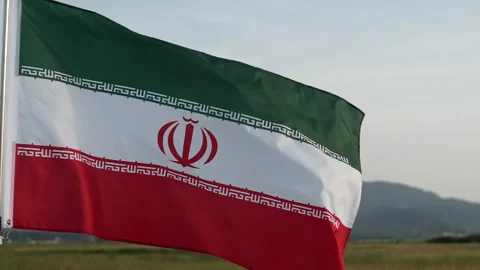 Iran flag waving in the wind against sunset, cloud sky, outdoor background Stock Footage 299963686
