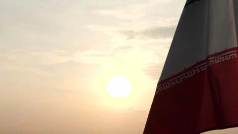 Iran flag waving in the wind against sunset, cloud sky, outdoor background Stock Footage 299965351