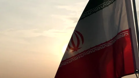 Iran flag waving in the wind against sunset, cloud sky, outdoor background Stock Footage 299965717