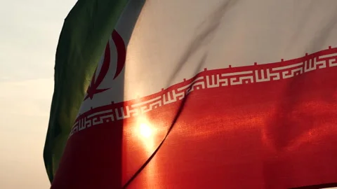 Iran flag waving in the wind against sunset, cloud sky, outdoor background Stock Footage 299966169
