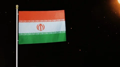 Iran / Iranian flag blowing in the wind against fire and ash &amp; black backdrop Stock Footage 110770696
