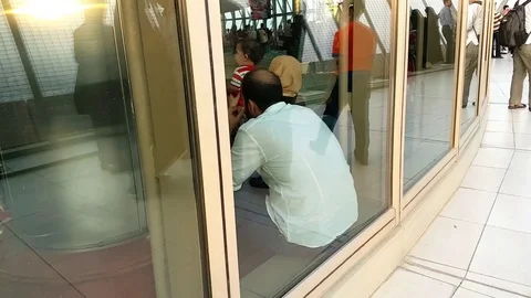 Iran: Reflection of people walking on the windows of top floor of Milad tower Stock Footage 69937908